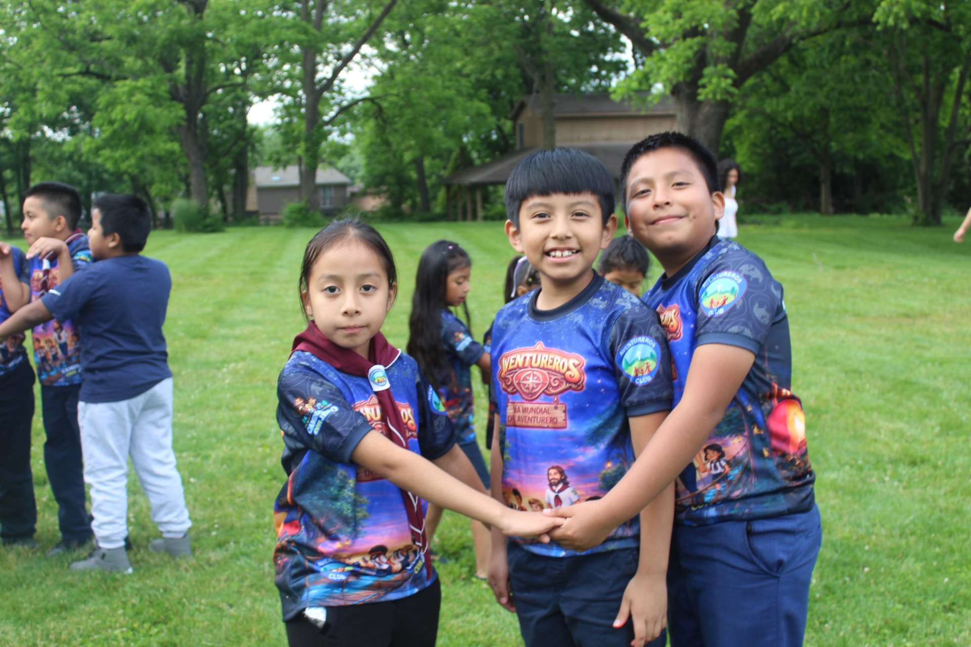 Adventurers holding hands at camp